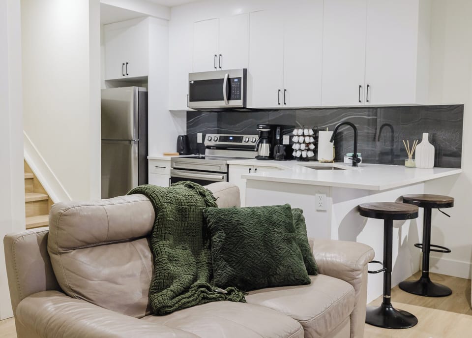 The living room features a roomy sofa , armchairs, a flat screen tv