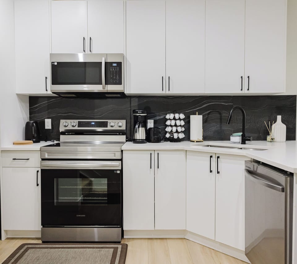 The living room features a roomy sofa , armchairs, a flat screen tv