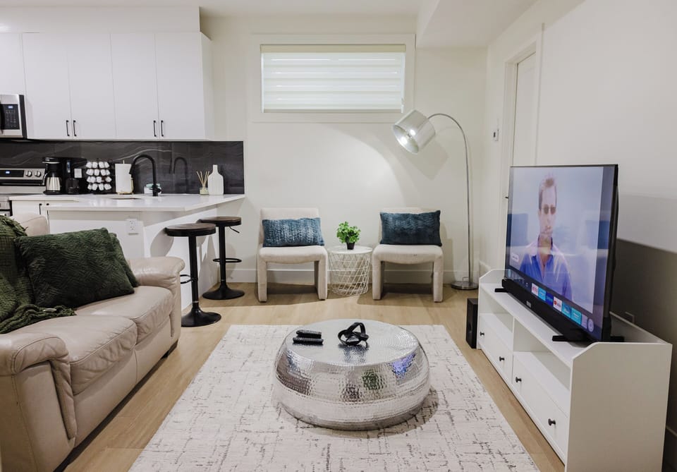 The living room features a roomy sofa , armchairs, a flat screen tv