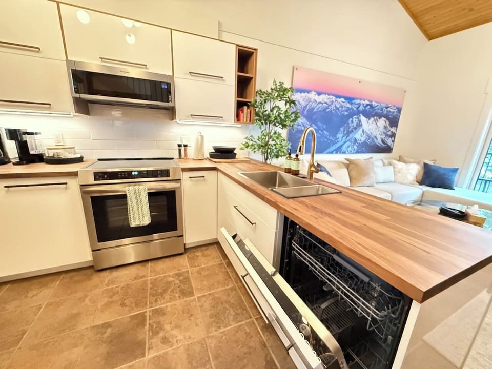 Efficient Layout: Enjoy this thoughtfully designed kitchen with a new built-in dishwasher, new microwave, and extensive countertop space for easy cooking and entertaining.