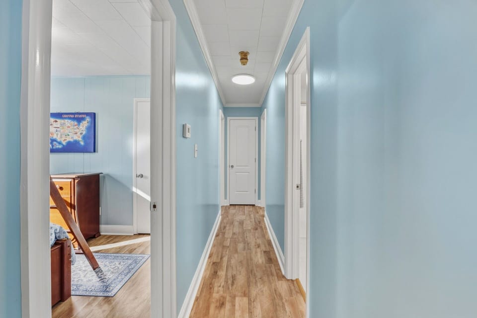 The home's central location provides easy access to beaches, dining, and iconic Outer Banks attractions.
