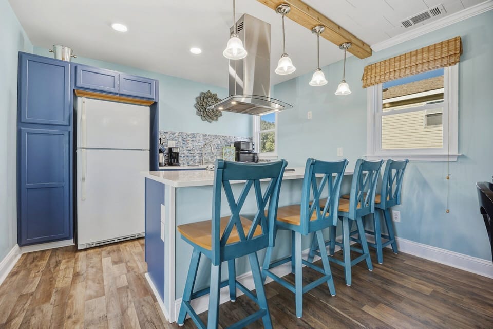 Breakfast bar seating provides convenient additional space for casual dining or morning coffee.