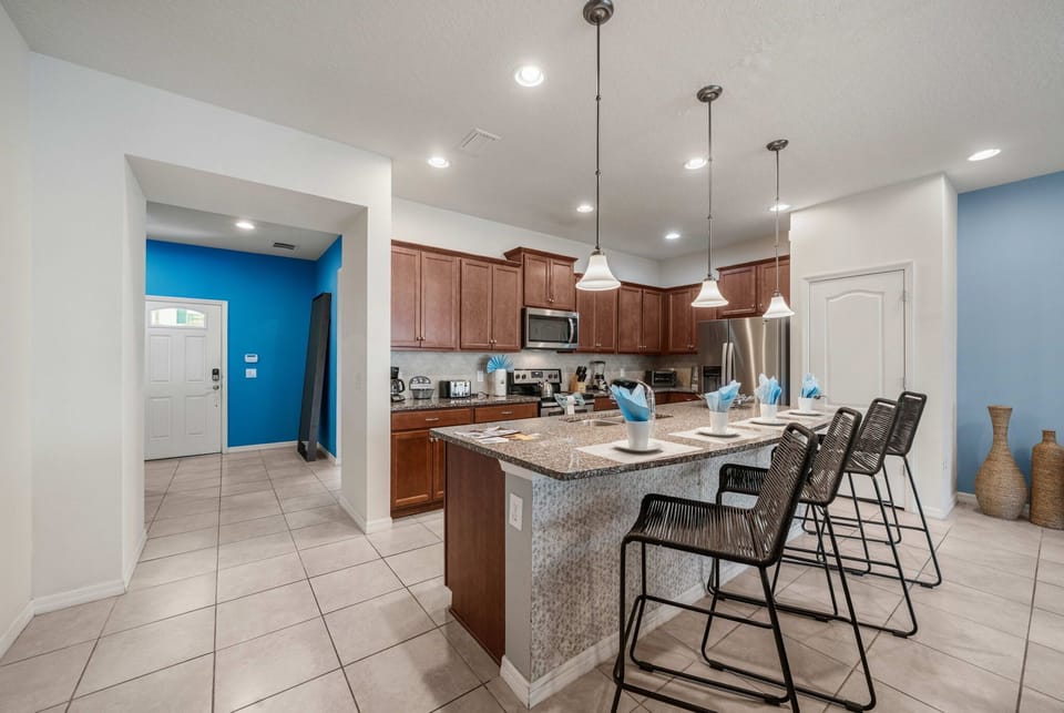 Bright contemporary kitchen with pendant lights and a spacious breakfast bar for 4-perfect for morning coffee and planning the day.