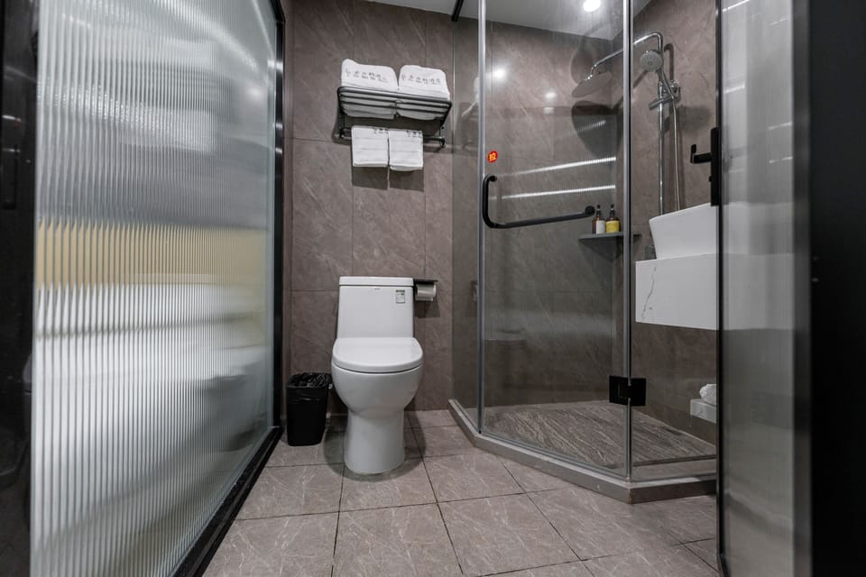 Shower, hair dryer, slippers, towels