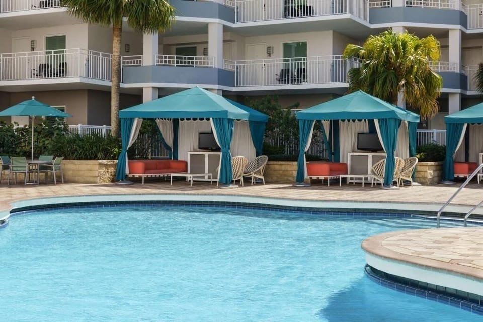 Unwind poolside in a shaded cabana with cool breezes.