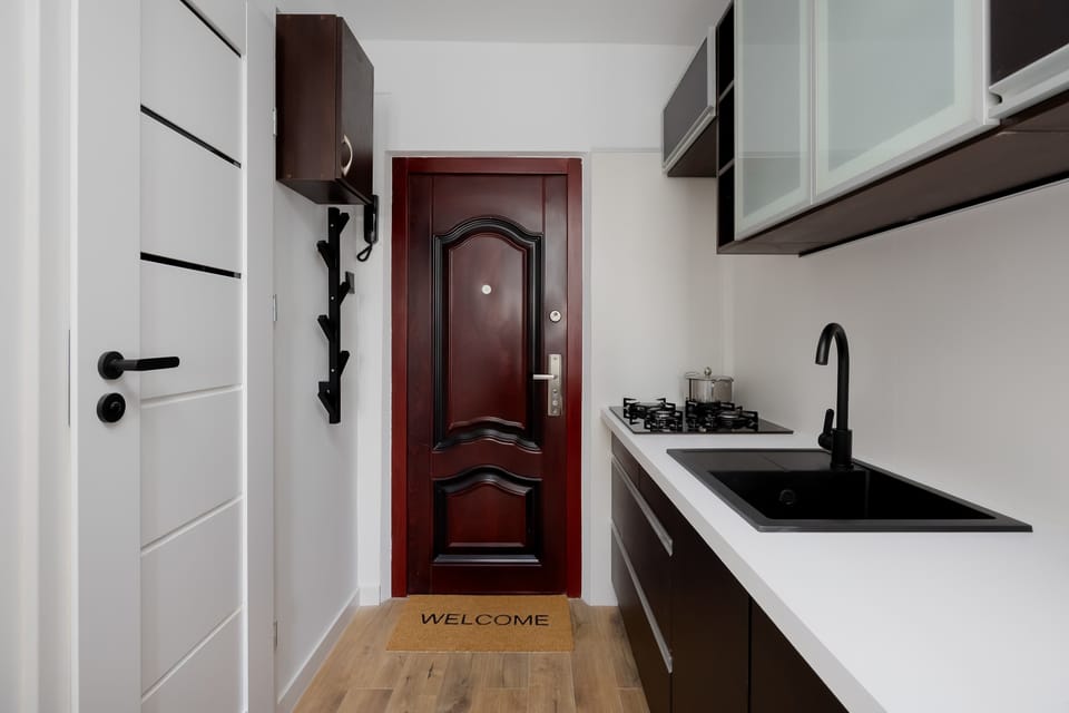 Compact kitchenette with clean, modern finishes, practical cabinetry, and countertop workspace.