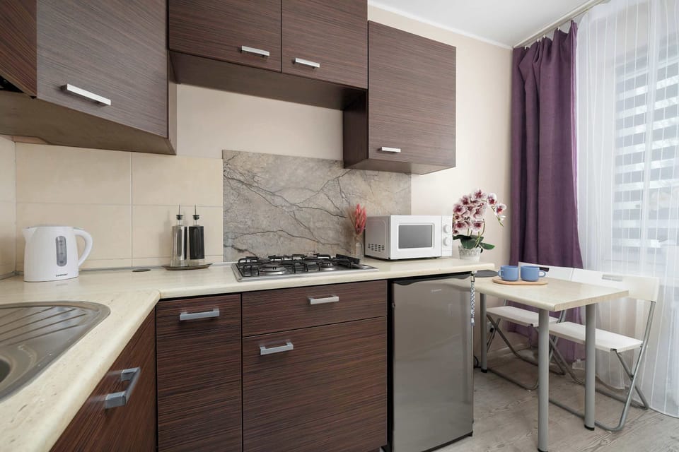 Functional kitchenette featuring base cabinets, sink, and efficient countertop space.