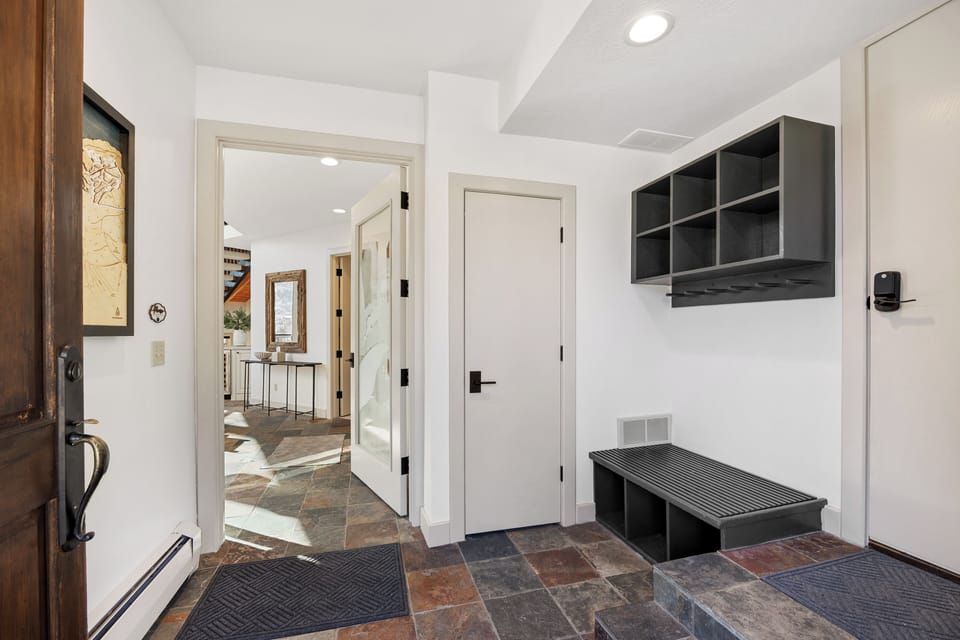 Well-designed mudroom with built-in storage and bench seating, offering convenient entry access and space for outdoor gear.
