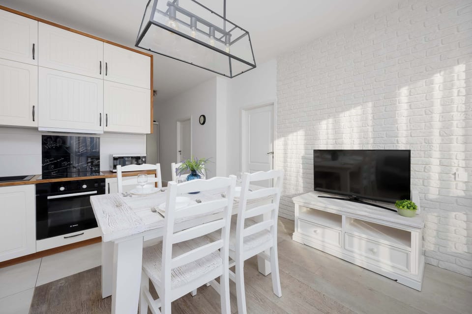 Dining area with table and bright kitchen.