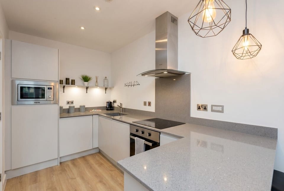 Cook with ease in the sleek kitchen with hob, oven and stylish lighting.