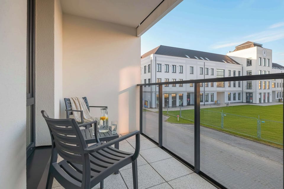 The balcony with seating offers a pleasant spot to enjoy fresh air and relax at any time of day.