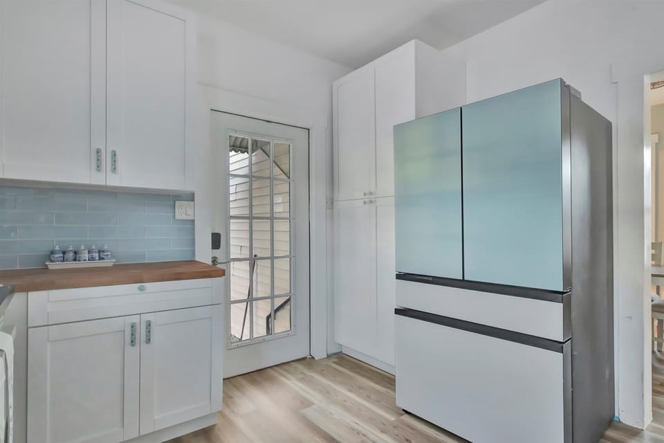 Kitchen with stainless steel refrigerator