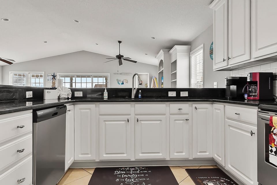 Open kitchen area with tons of counter space, multiple coffee makers, dishwasher, and more!