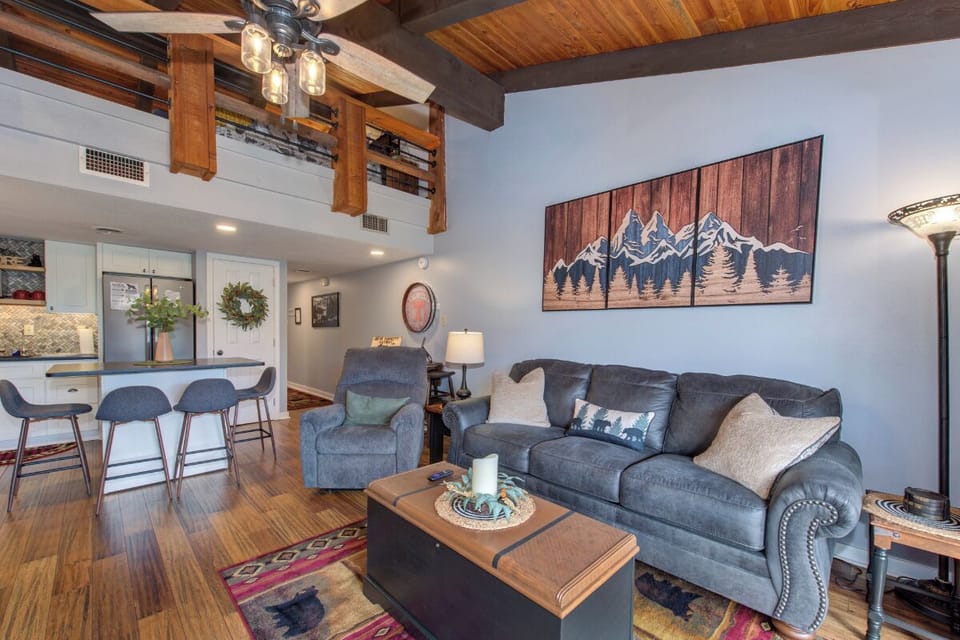 Unwind in your mountain-inspired living room where rustic beams meet modern comfort, perfect for cozy evenings after your adventures.