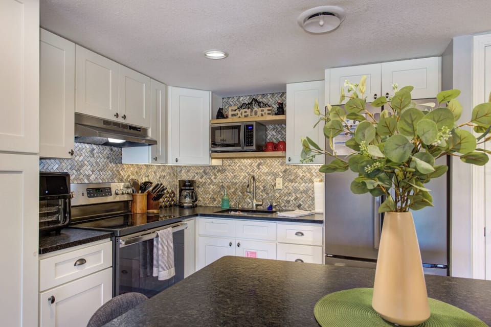 Your fully equipped kitchen features granite counters and modern appliances, perfect for preparing memorable meals during your stay.