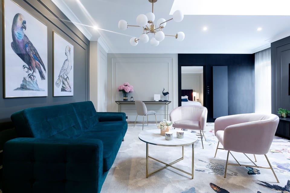 Relax together on velvet seating beneath a modern statement chandelier.