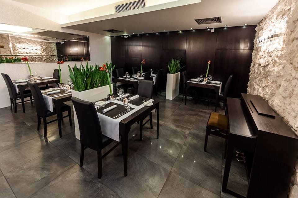 Savor elegant dinners in a moody, intimate dining room.