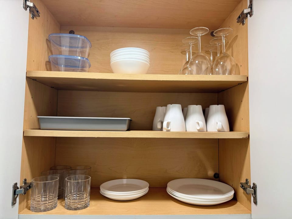 Well-organized coffee and tea area with cups, dishes, and essentials for daily use