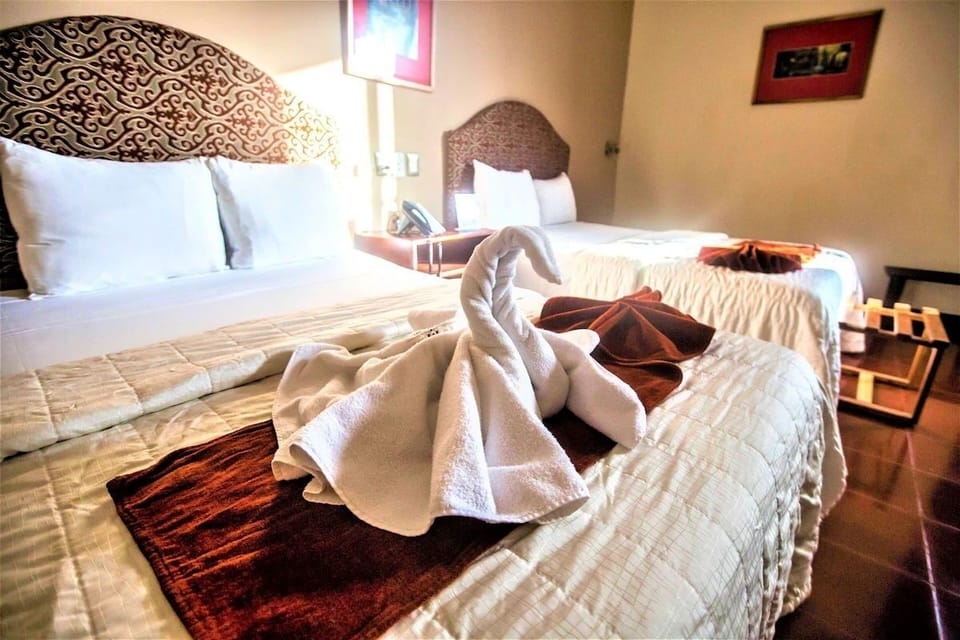Feel welcomed with charming towel art and smooth, cozy linens.