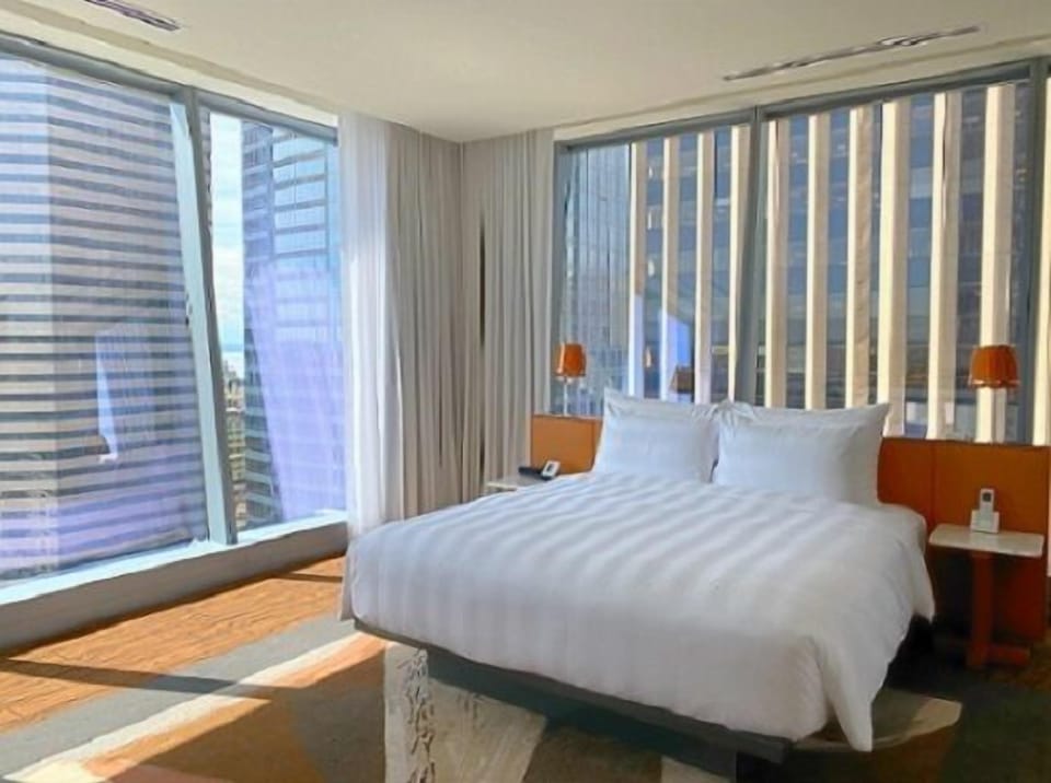 Wake up to soaring windows and a sunlit, plush bed.