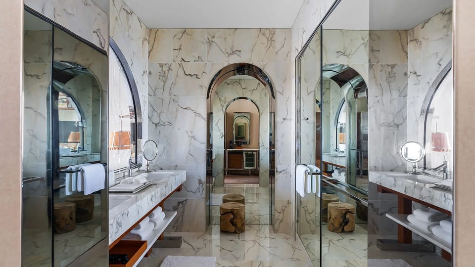 Indulge in a serene, marble bathroom with generous space.