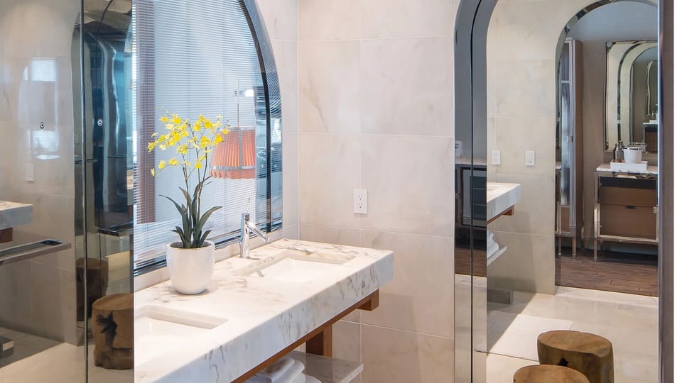 Refresh at the marble vanity with spa-like finishes and light.