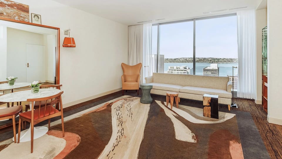 Lounge by panoramic windows and savor the waterfront skyline.