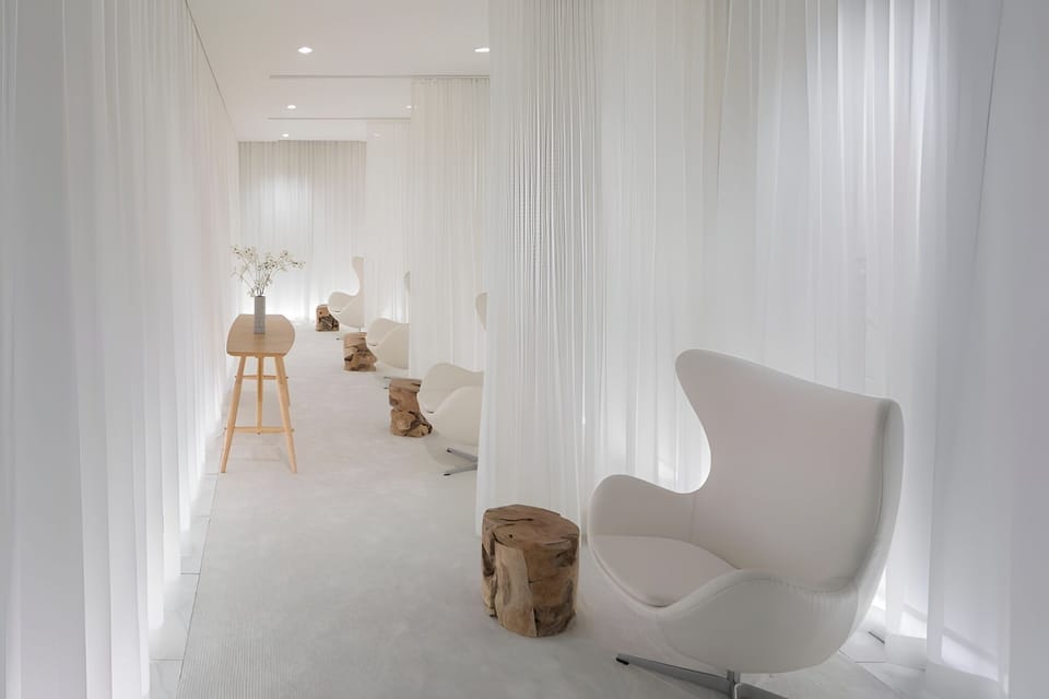 Recharge quietly in a tranquil spa lounge with soft drapery.