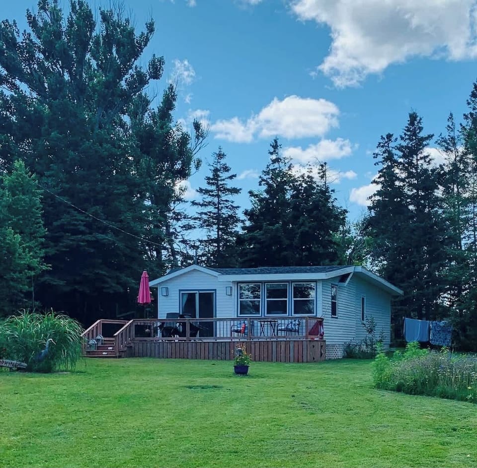 Cottage with lawn and gardens.