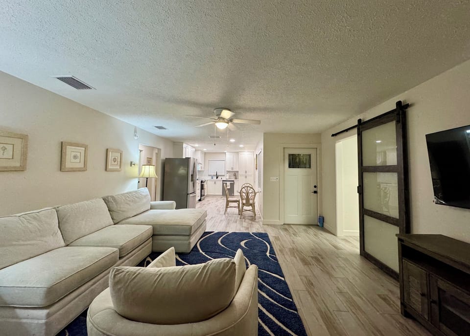 Living room with View to the kitchen. Utility room to the right.