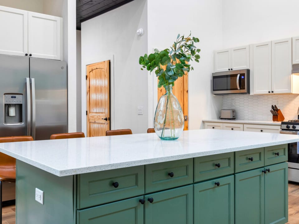 Stainless steel kitchen appliances and a large counter