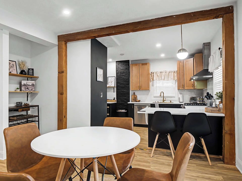 Round dining table set beside sliding doors to the kitchen