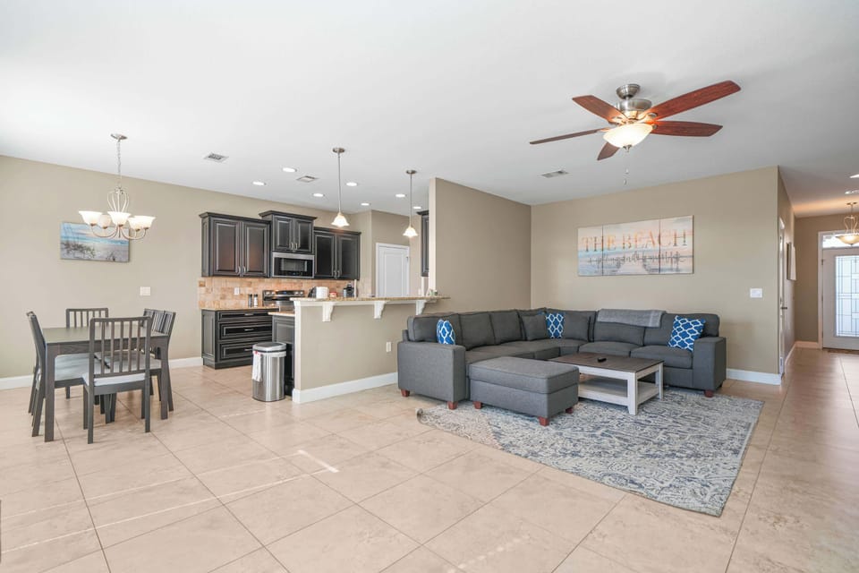 Living Room Section Couch w/ Smart TV & Foosball Table w/ Dining Area & Kitchen View