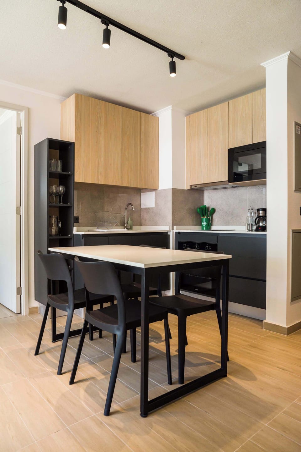 Sleek and modern kitchen with dining area, perfect for cozy meals in your private apartment.