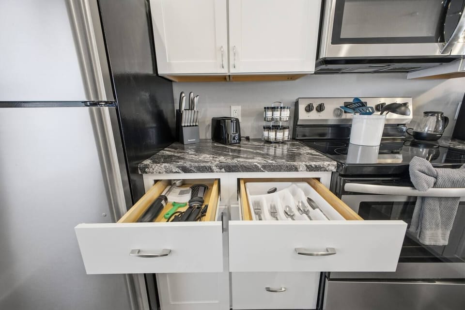 Fully stocked kitchen with utensils, spices & stainless appliances