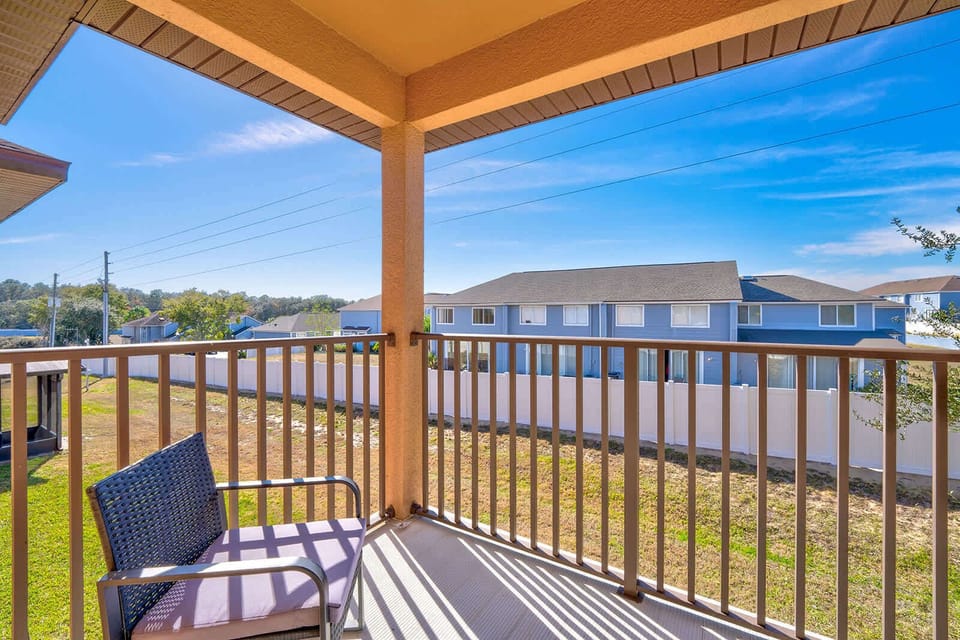 Spacious covered balcony w/ sweeping views — ideal for morning coffee or sunset drinks.
