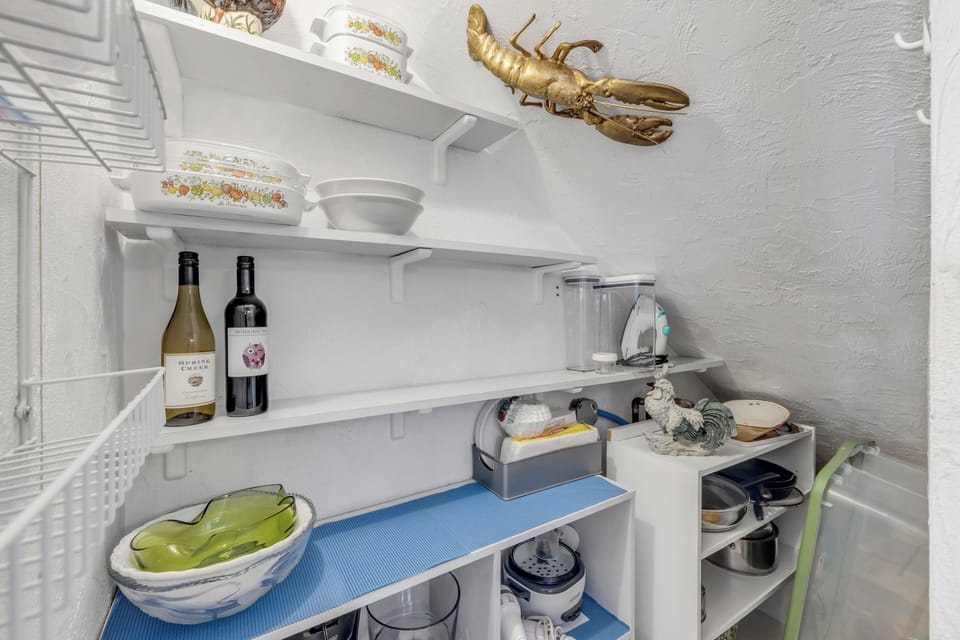A large pantry provides ample storage space, making it easy to stock up and stay organized during your beach getaway