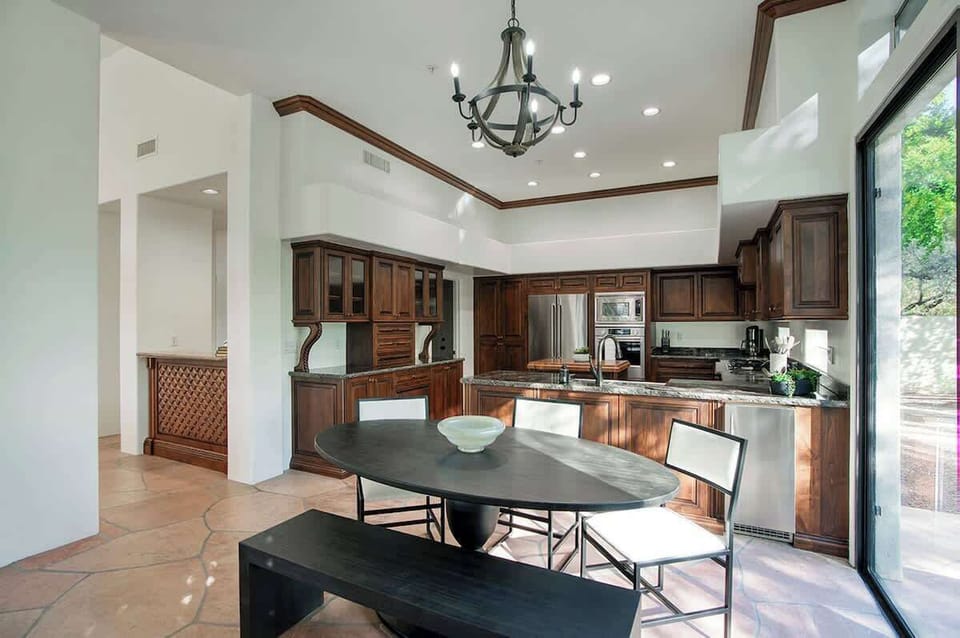 Non-formal dining area for 6 and private access to outdoor patio with outdoor dining table for 6 and built-in BBQ grill.
