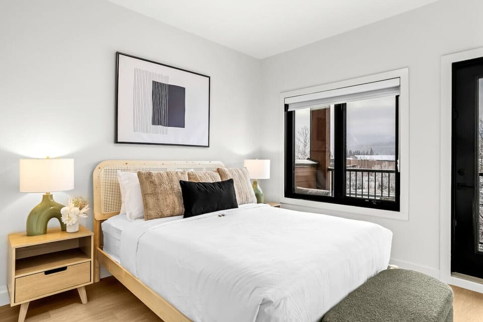 A cozy and spacious queen bedroom featuring a flat-screen TV, and a private ensuite bathroom for added convenience.