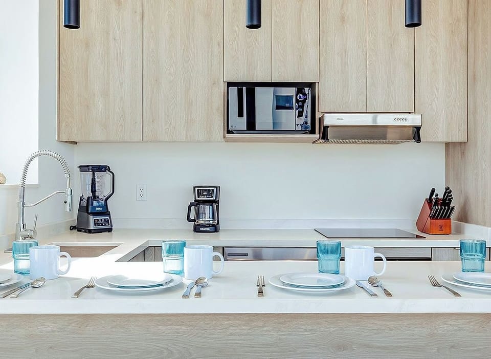 Cook with ease in your sleek modern kitchen featuring premium appliances and a dining bar for memorable meals together.