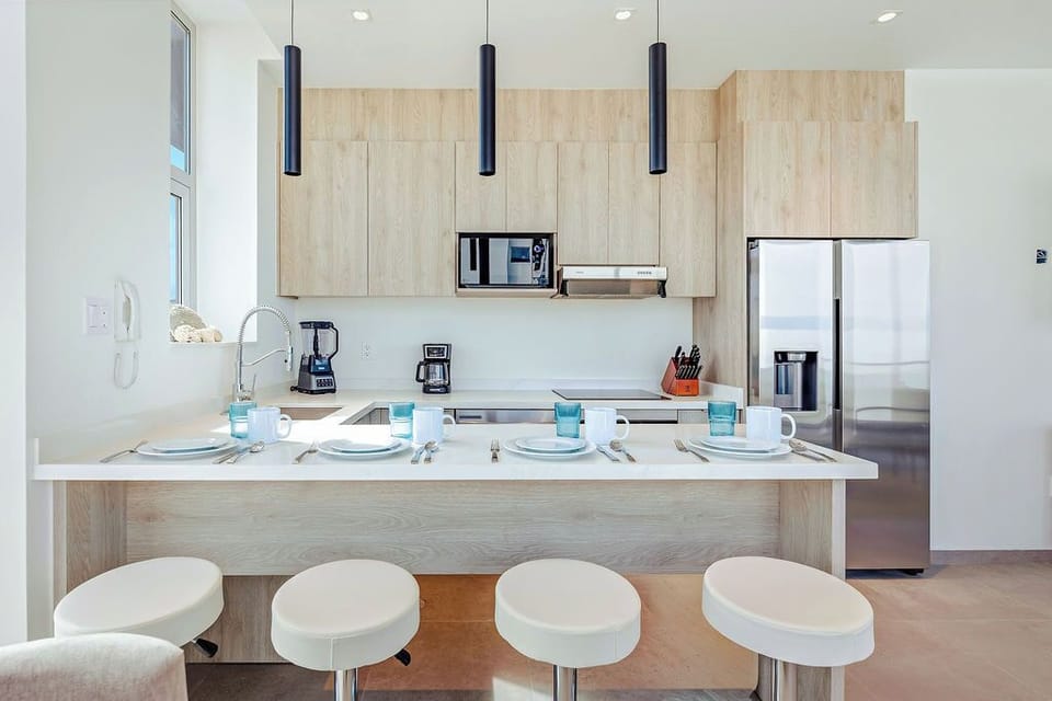 Your modern kitchen awaits with sleek pendant lighting, premium appliances, and a breakfast bar where morning coffee tastes even better.