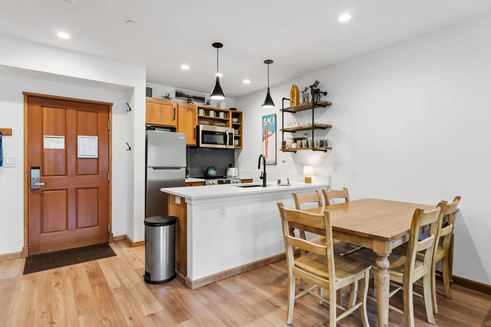 Gather around your beautiful dining table in this bright, modern kitchen where shared meals become cherished memories.