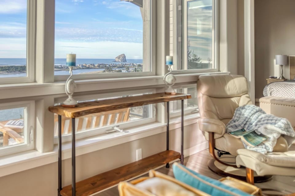 Relax in your cozy reading chair while soaking in panoramic ocean views through expansive windows.