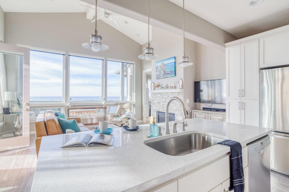 Your bright, open kitchen flows into the living area where stunning ocean views fill every window.