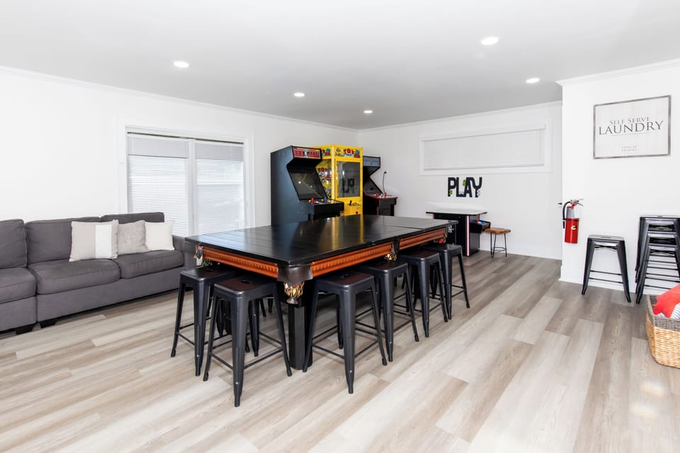 Your game room awaits with arcade classics, pool table, and cozy seating for endless entertainment and friendly competition.