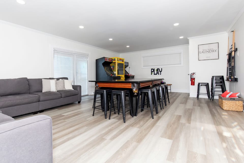 Your entertainment space awaits with arcade games, pool table, and comfy seating for endless fun with family and friends.
