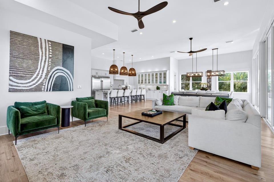 2nd floor -Spacious great room designed for gathering and relaxing, featuring comfortable lounge seating, an open-concept layout, and seamless flow to the kitchen and dining areas—perfect for family time, group entertaining, and making memories at Ocean’s 
