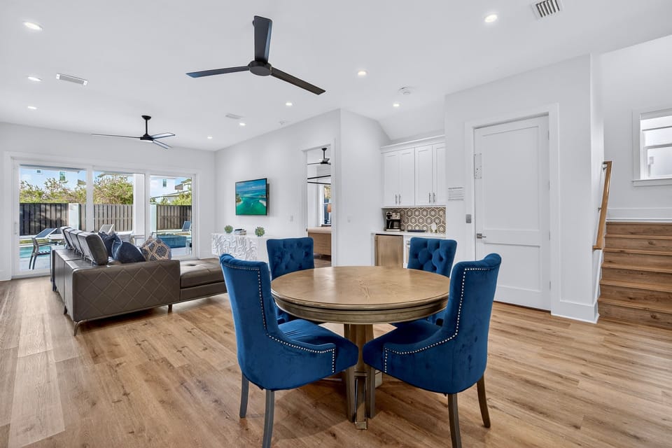 1st floor - entertainment lounge with plush seating, poker table, and a wet bar with fridge, microwave, and coffee maker—plus direct walk-out access to the pool deck for seamless indoor-outdoor living and easy poolside fun.