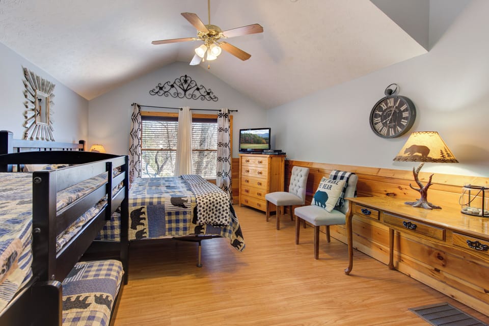 You'll love this cozy bedroom with rustic charm, featuring comfortable bunk beds and twin bed perfect for family gatherings.