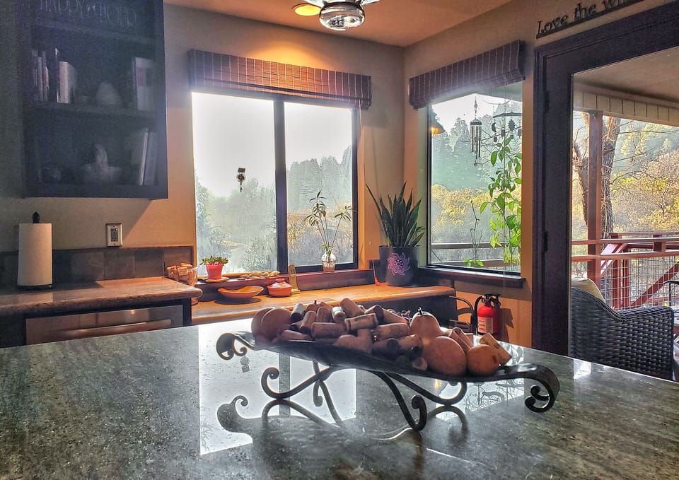 Gather around the spacious kitchen island as sunlight streams through large windows, creating a warm space for cooking and connecting.
